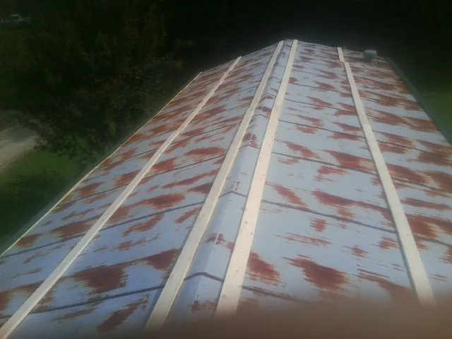Rusted metal roof panels with new wood purlins before replacement — Storm Damage Roof Repair in Bandera by Roofing Brothers